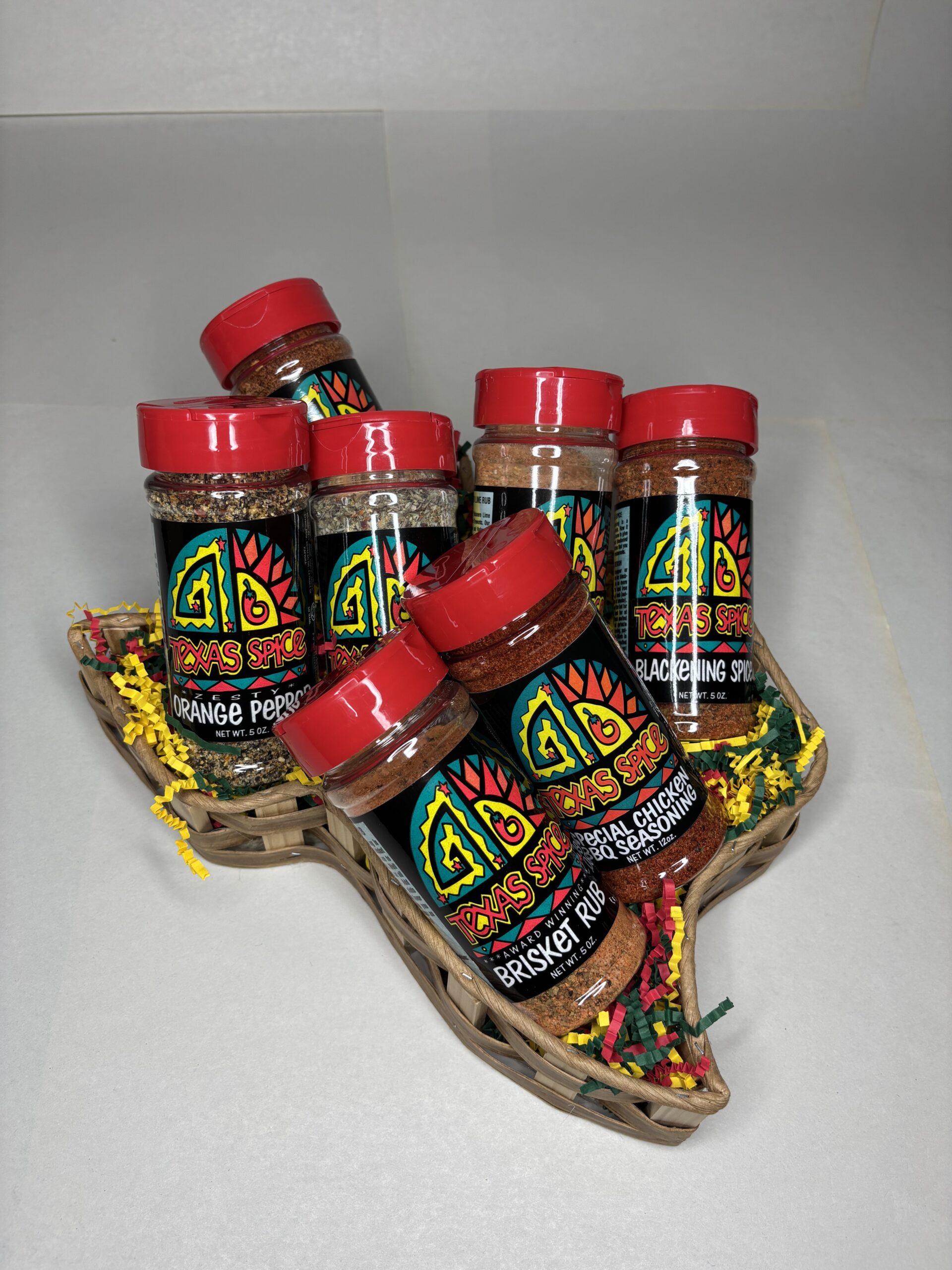 Texas Spice Custom 7 Spice Blend Gift Basket filled with shaker bottles with red lids on a white background
